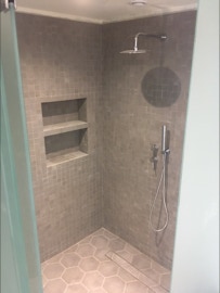 Mosaico hidráulico monocromático na parede e pavimento num chuveiro